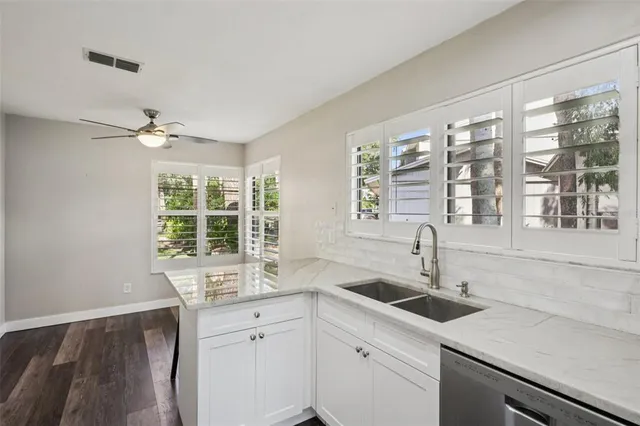 a kitchen with a sink and large window
