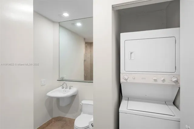a bathroom with a sink toilet and mirror