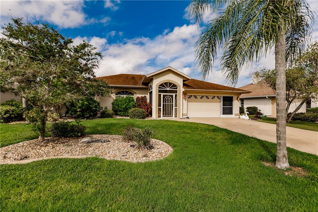 1461 Navigator Road Punta Gorda, FL 33983 - Photo 1 of 1 a view of a house with a big yard and potted plants
