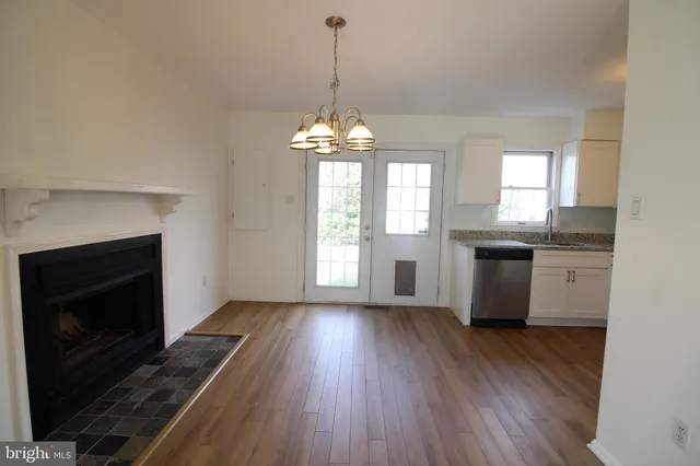 a kitchen with wooden floors and white appliances