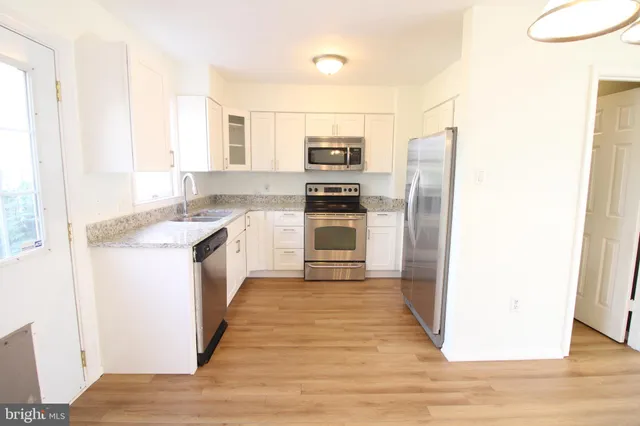 a kitchen with a refrigerator stove and oven