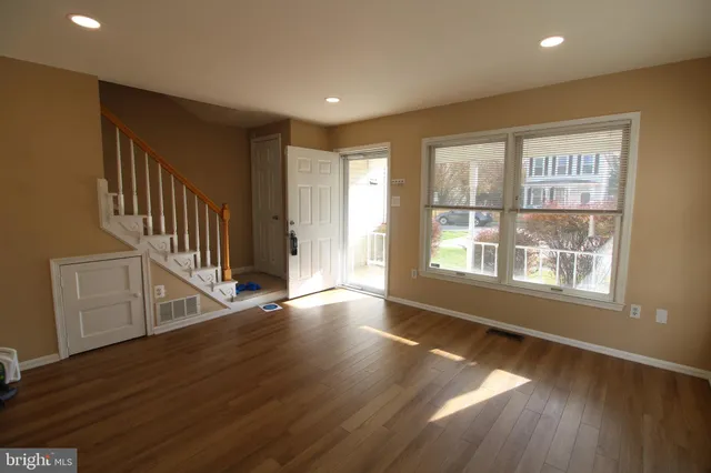 a view of an entryway with wooden floor