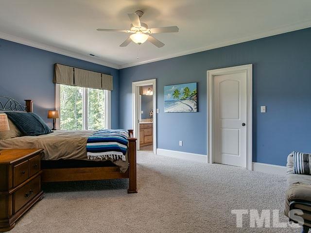 2309 Mt Vernon Church Road Raleigh, NC 27614 - Photo 14 of 25 a bedroom with a bed and a chandelier