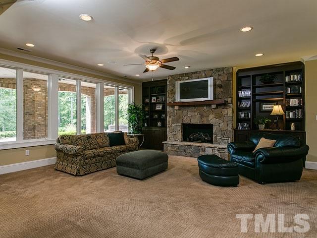 2309 Mt Vernon Church Road Raleigh, NC 27614 - Photo 17 of 25 a living room with furniture a flat screen tv and a fireplace