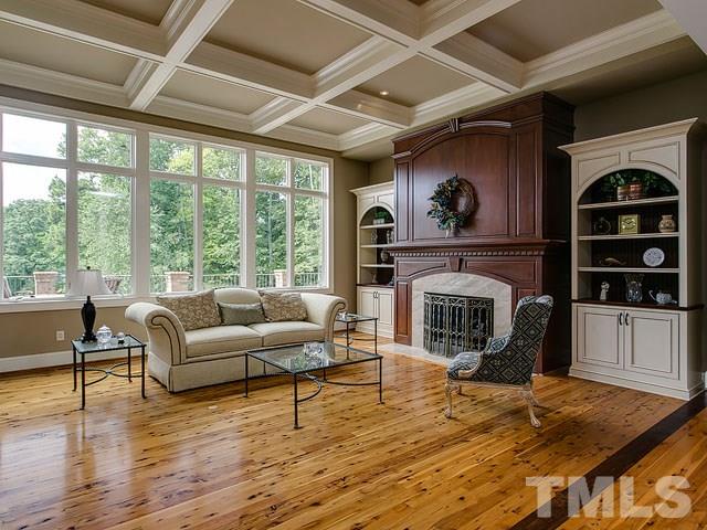 2309 Mt Vernon Church Road Raleigh, NC 27614 - Photo 8 of 25 a living room with furniture a fireplace and a floor to ceiling window