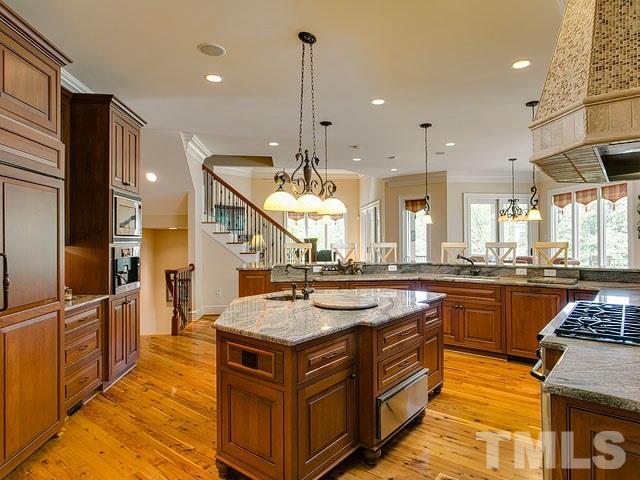 2309 Mt Vernon Church Road Raleigh, NC 27614 - Photo 10 of 25 a kitchen with stainless steel appliances granite countertop a sink a stove and a refrigerator