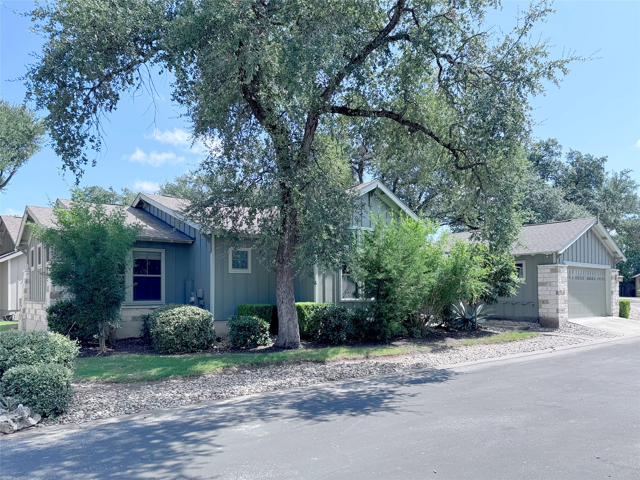 9707 Anderson Mill Road, Unit 21 Austin, TX 78750 - Photo 2 of 27 Mature trees shade this charming single-story home featuring board and batten siding.