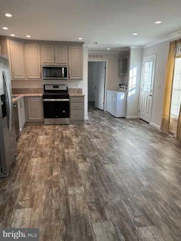 a large kitchen with cabinets and stainless steel appliances