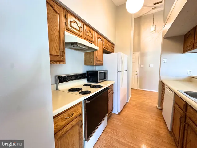 a kitchen with stainless steel appliances granite countertop a stove and a refrigerator