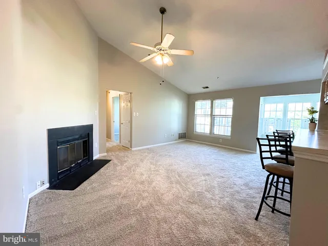 a view of a livingroom with furniture and chandelier fan