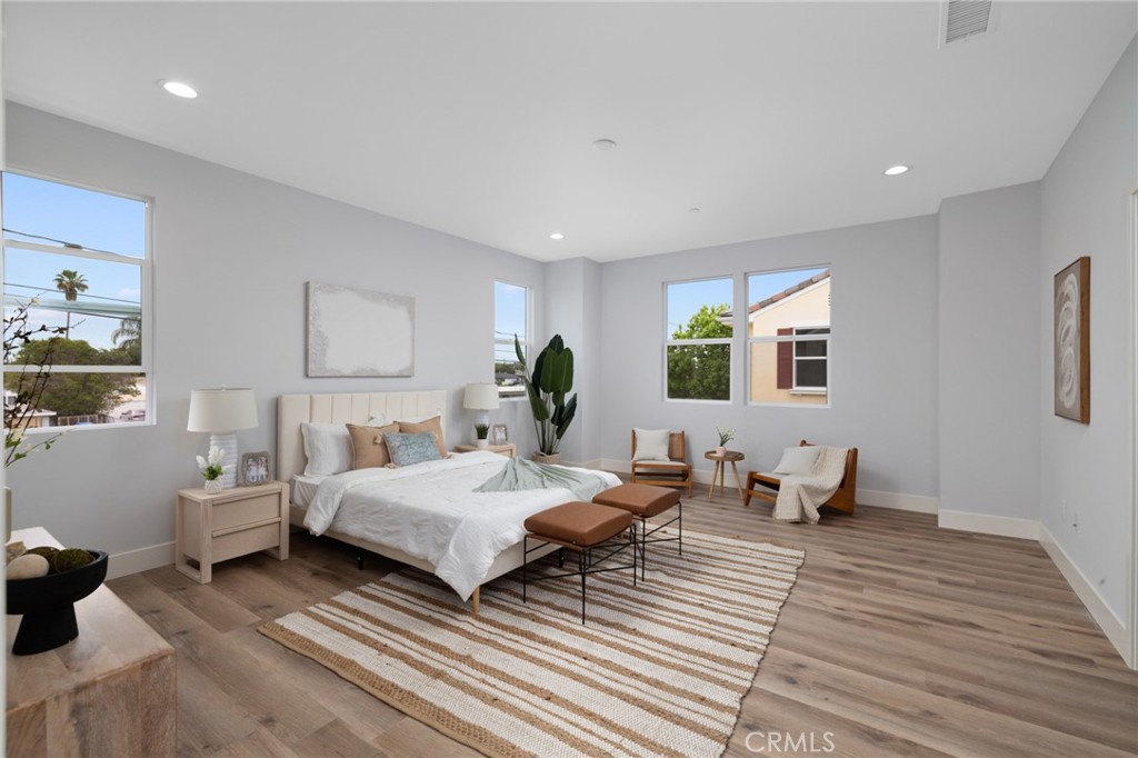 11237 Gladhill Road, Unit 4 Whittier, CA 90604 - Photo 19 of 34 a bedroom with a bed and wooden floor