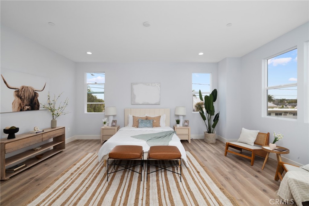 11237 Gladhill Road, Unit 4 Whittier, CA 90604 - Photo 21 of 34 a bedroom with a bed and wooden floor