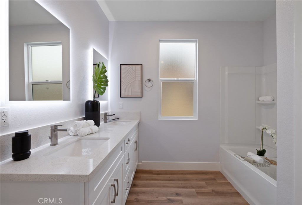 11237 Gladhill Road, Unit 4 Whittier, CA 90604 - Photo 22 of 34 a bathroom with a granite countertop sink mirror and bathtub