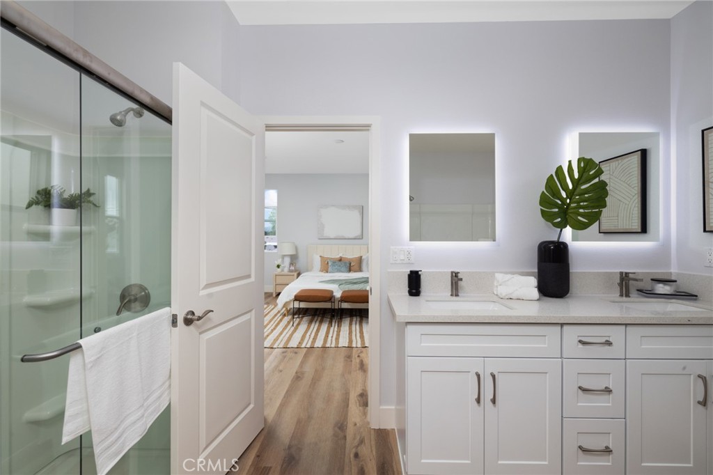 11237 Gladhill Road, Unit 4 Whittier, CA 90604 - Photo 24 of 34 a en suite bathroom with a double vanity sink a mirror and shower