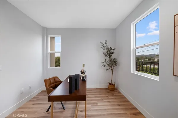 a view of a livingroom with furniture and a potted plant