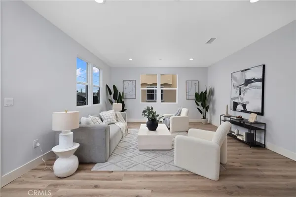 a living room with furniture or couch and a wooden floor