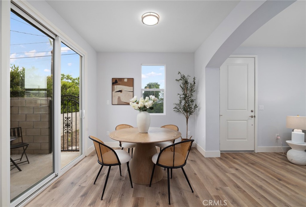 11237 Gladhill Road, Unit 4 Whittier, CA 90604 - Photo 9 of 34 a view of a dining room with furniture and wooden floor
