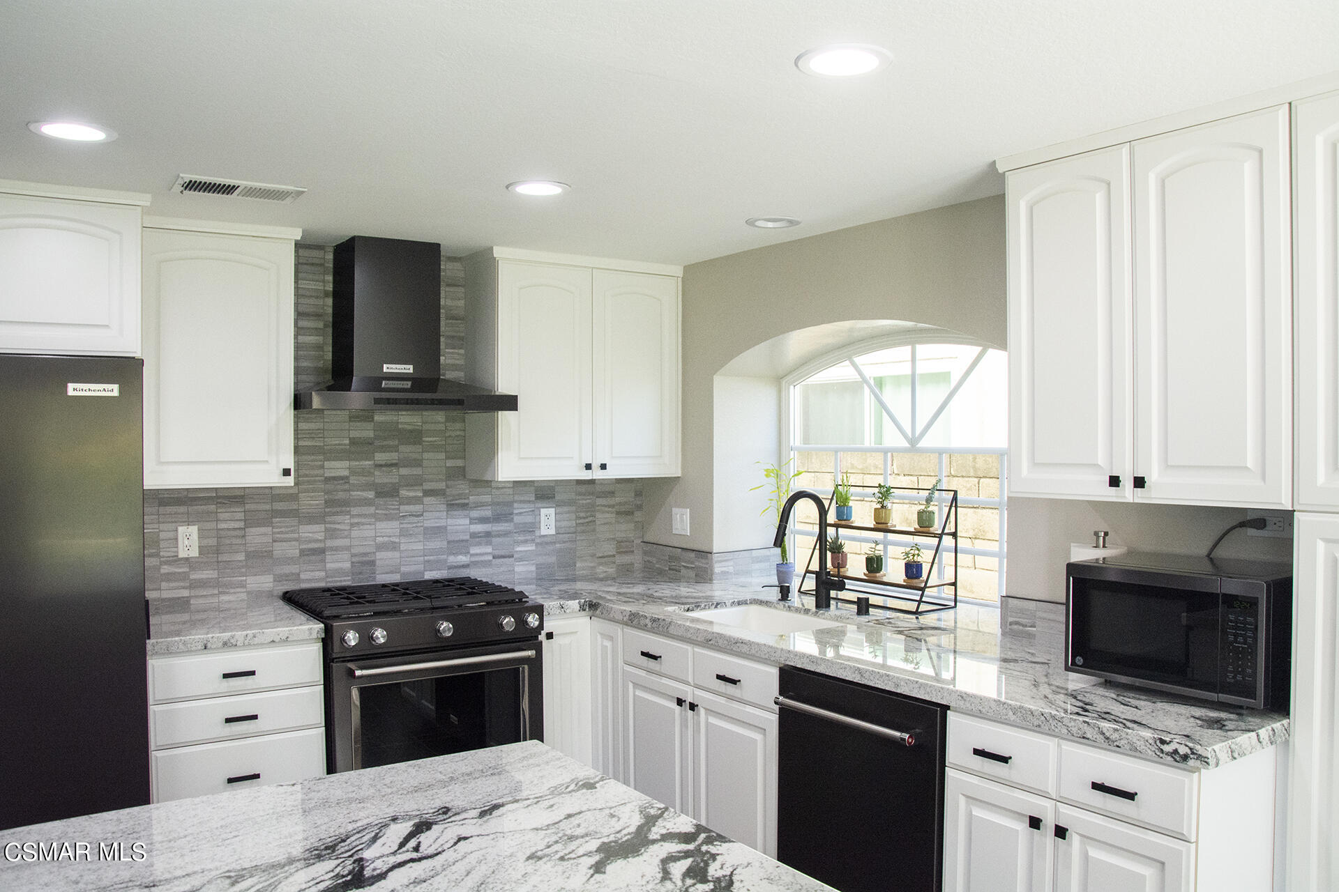 685 Overlook Road Simi Valley, CA 93065 - Photo 19 of 37 a kitchen with stainless steel appliances granite countertop a stove a sink and a microwave