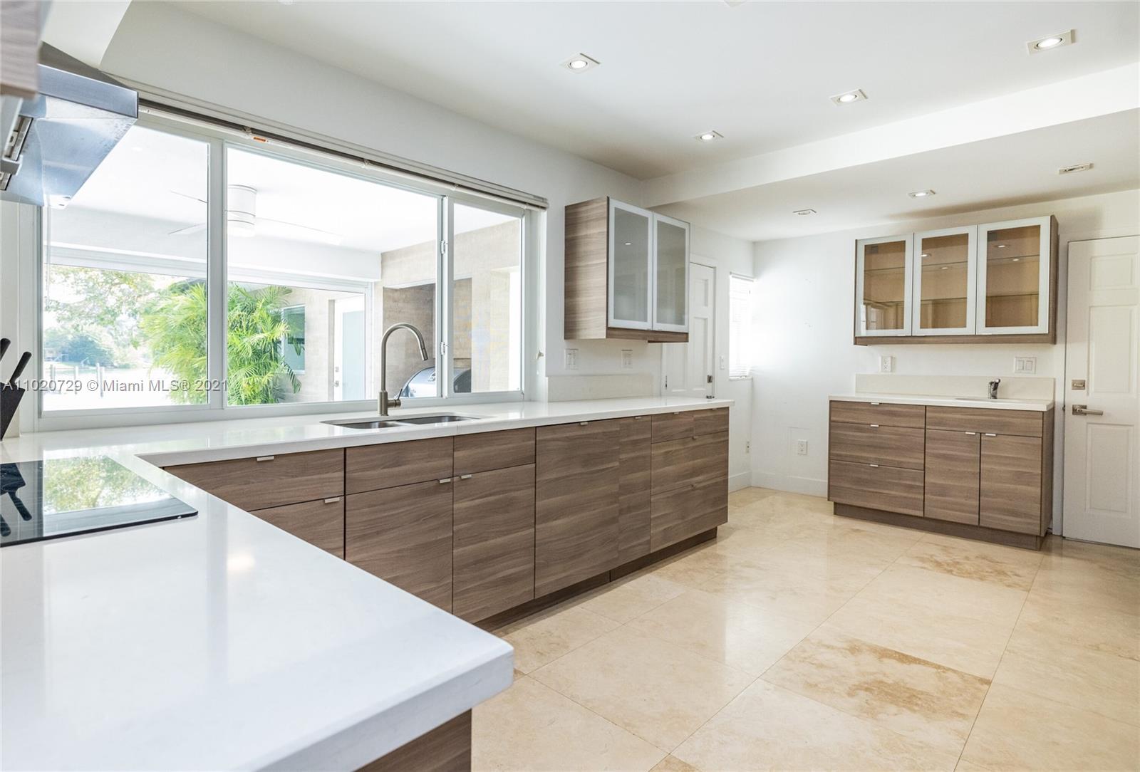 4765 Lake Road Miami, FL 33137 - Photo 29 of 100 a kitchen with stainless steel appliances kitchen island granite countertop a large window and a sink