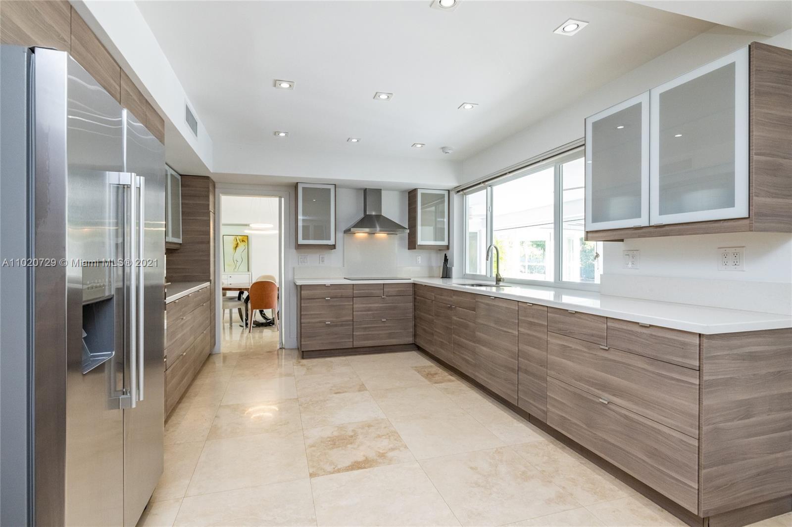 4765 Lake Road Miami, FL 33137 - Photo 30 of 100 a kitchen with stainless steel appliances a refrigerator sink and cabinets