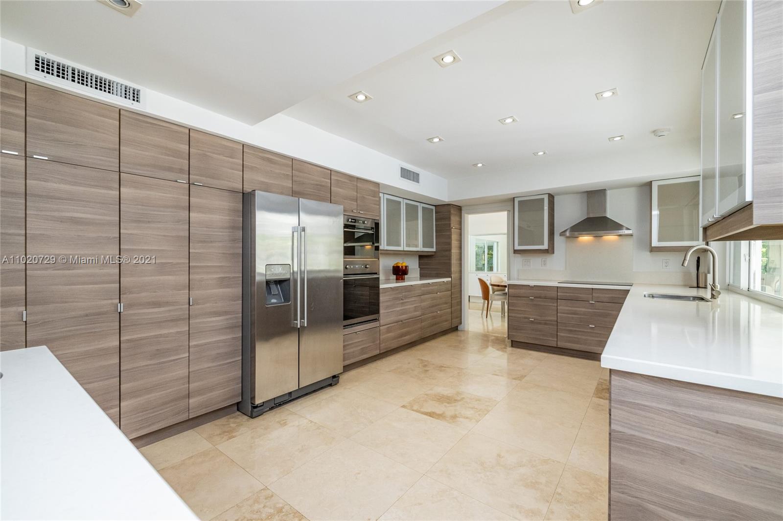 4765 Lake Road Miami, FL 33137 - Photo 32 of 100 a large kitchen with stainless steel appliances kitchen island a large counter top and a view of living room