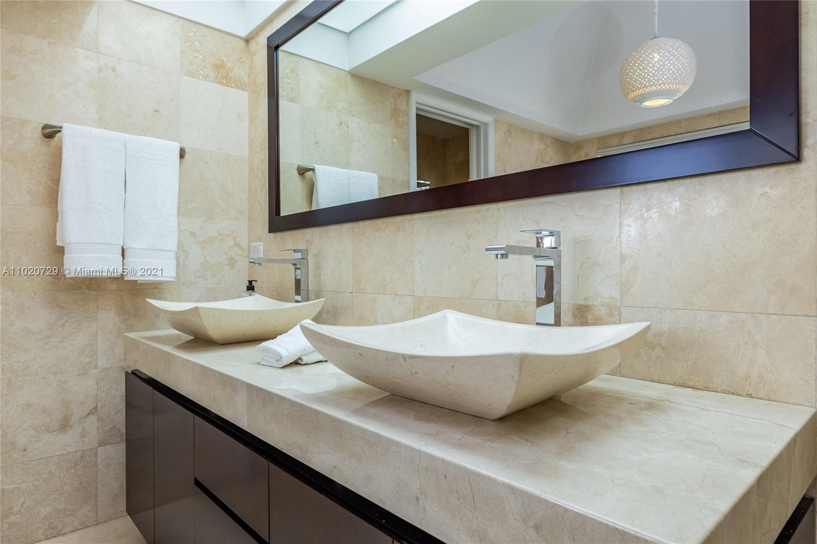 4765 Lake Road Miami, FL 33137 - Photo 42 of 100 a bathroom with a sink and a mirror