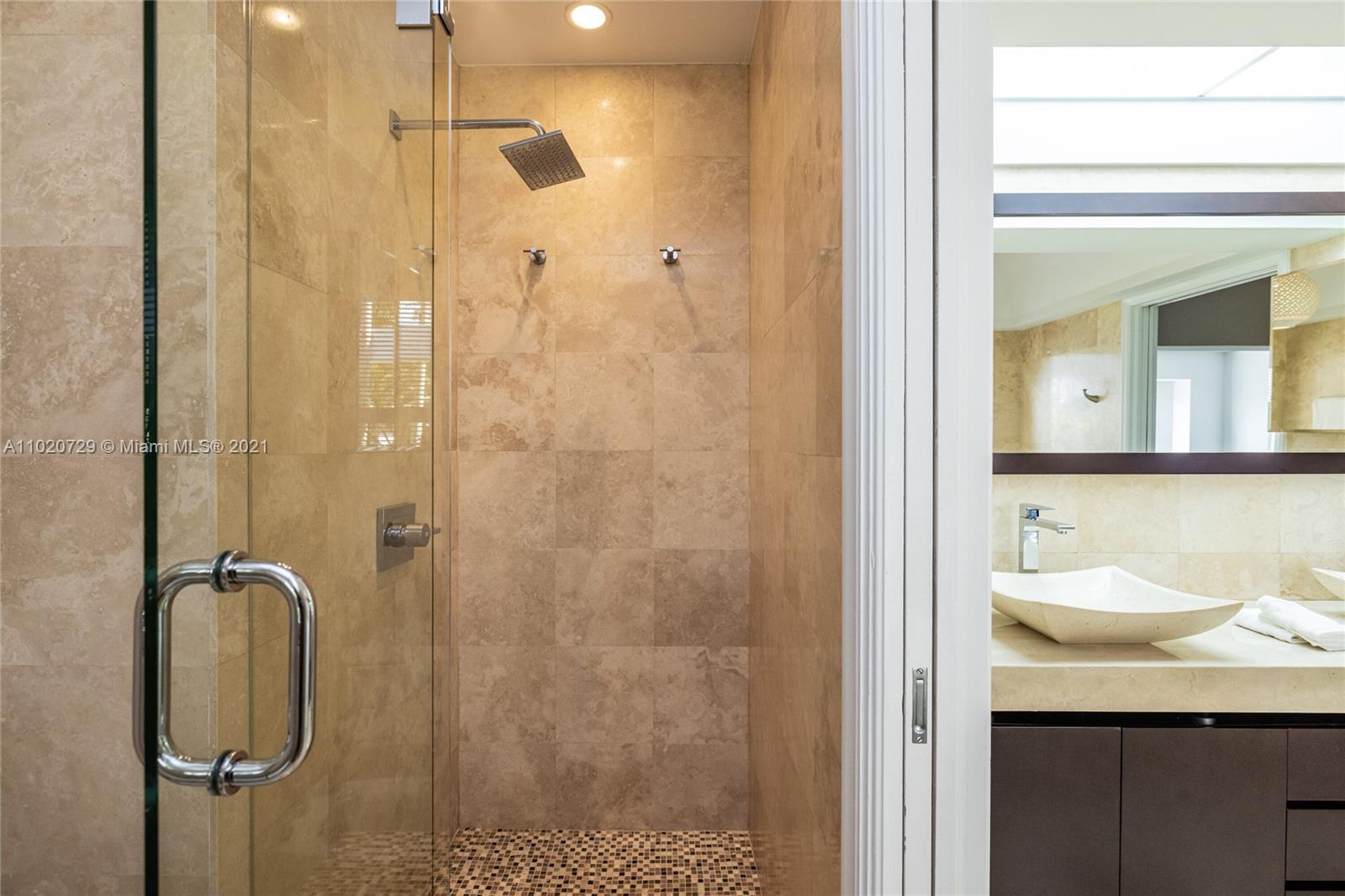 4765 Lake Road Miami, FL 33137 - Photo 44 of 100 a bathroom with a granite countertop sink a mirror and shower