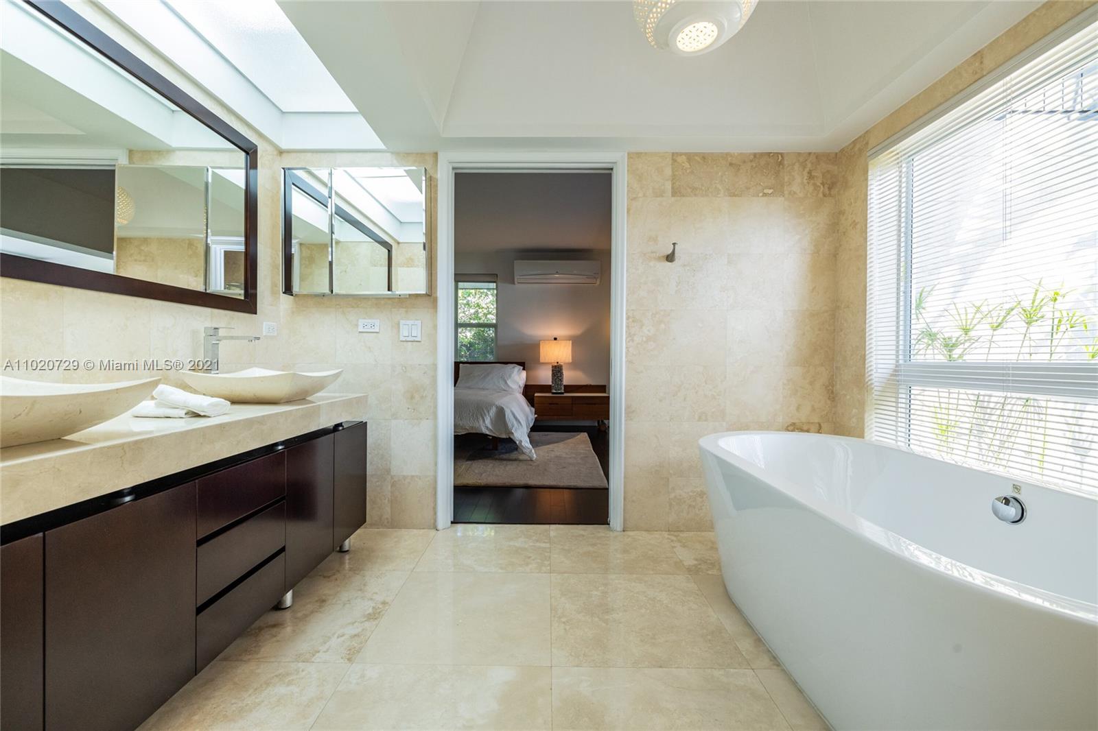 4765 Lake Road Miami, FL 33137 - Photo 45 of 100 a bathroom with a tub a sink and mirror