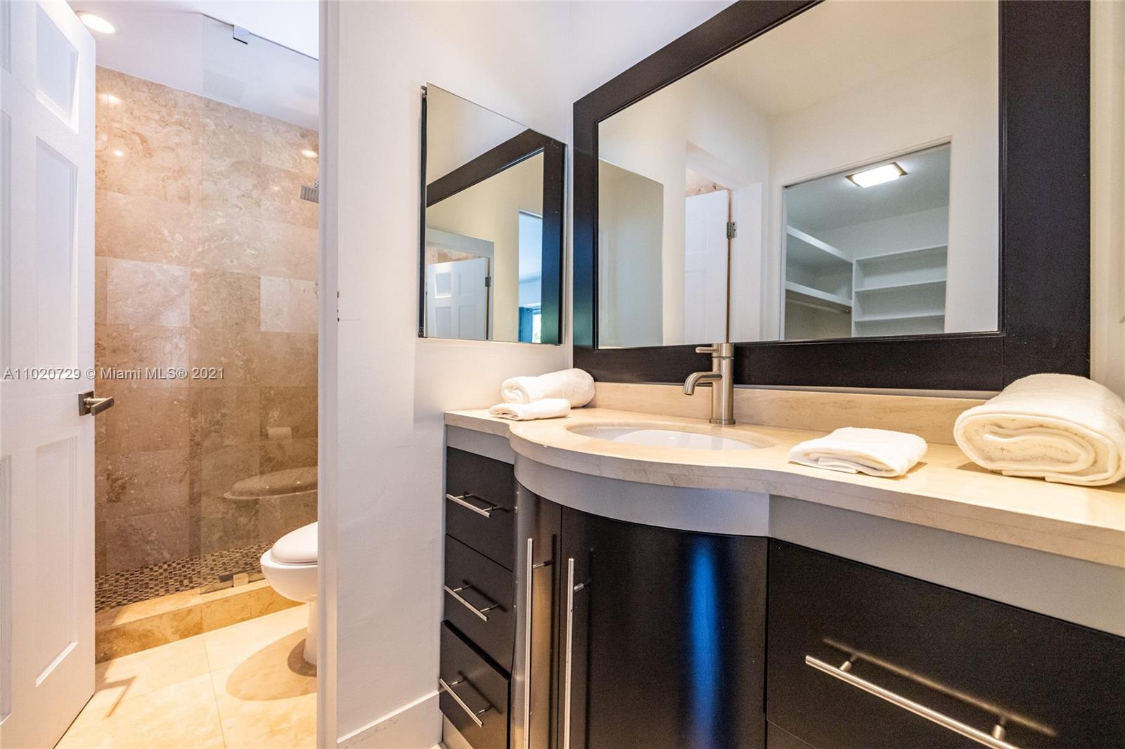 4765 Lake Road Miami, FL 33137 - Photo 52 of 100 a bathroom with a granite countertop sink a toilet and shower