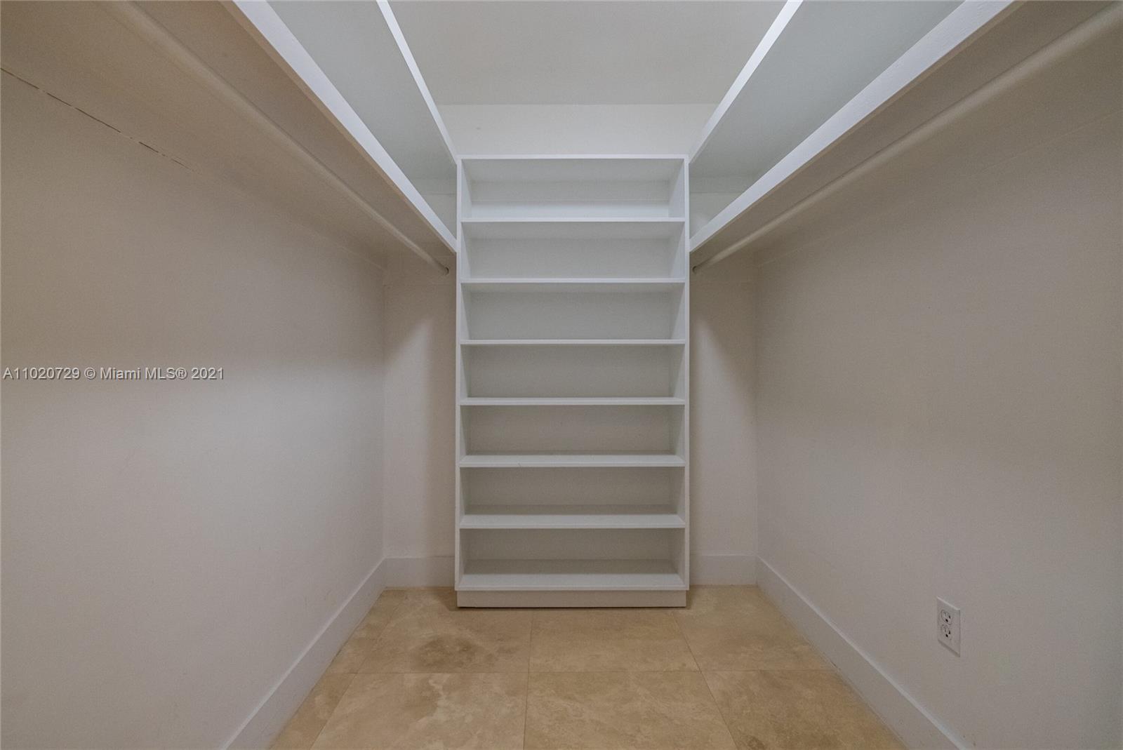 4765 Lake Road Miami, FL 33137 - Photo 53 of 100 a view of walk in closet with empty racks