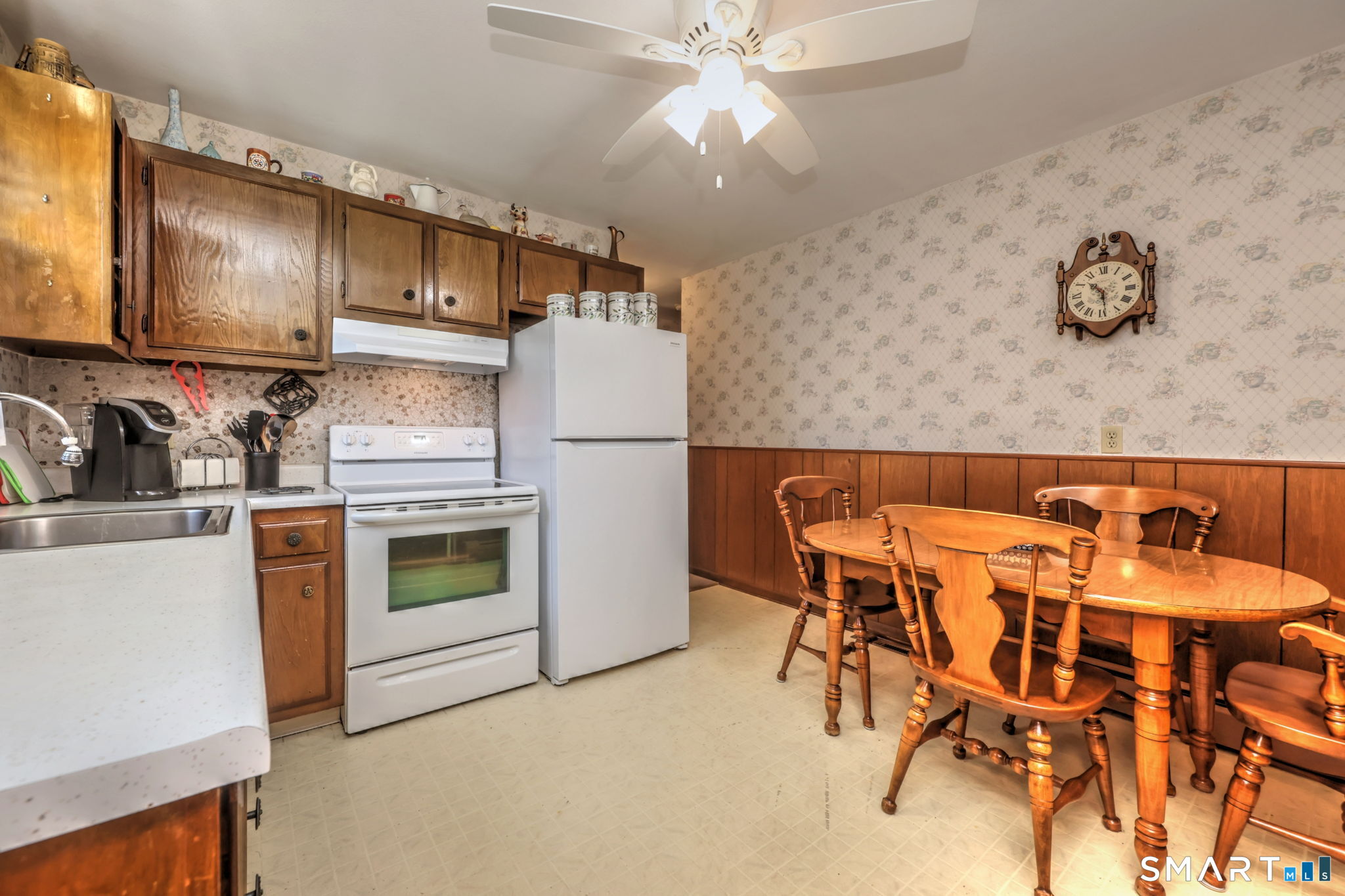 212 Swain Avenue Meriden, CT 06450 - Photo 17 of 38 a kitchen with a refrigerator and a stove top oven