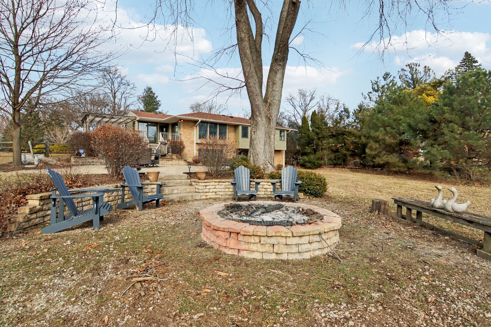 635 Signal Hill Road North Barrington, IL 60010 - Photo 39 of 69 a view of a backyard with table and chairs under a large tree