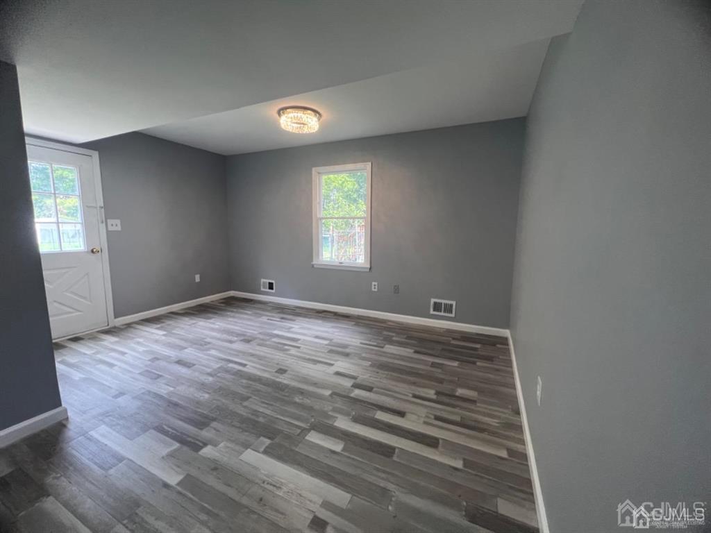 1577 Holly Road North Brunswick, NJ 08902 - Photo 13 of 15 a view of empty room with wooden floor and fan