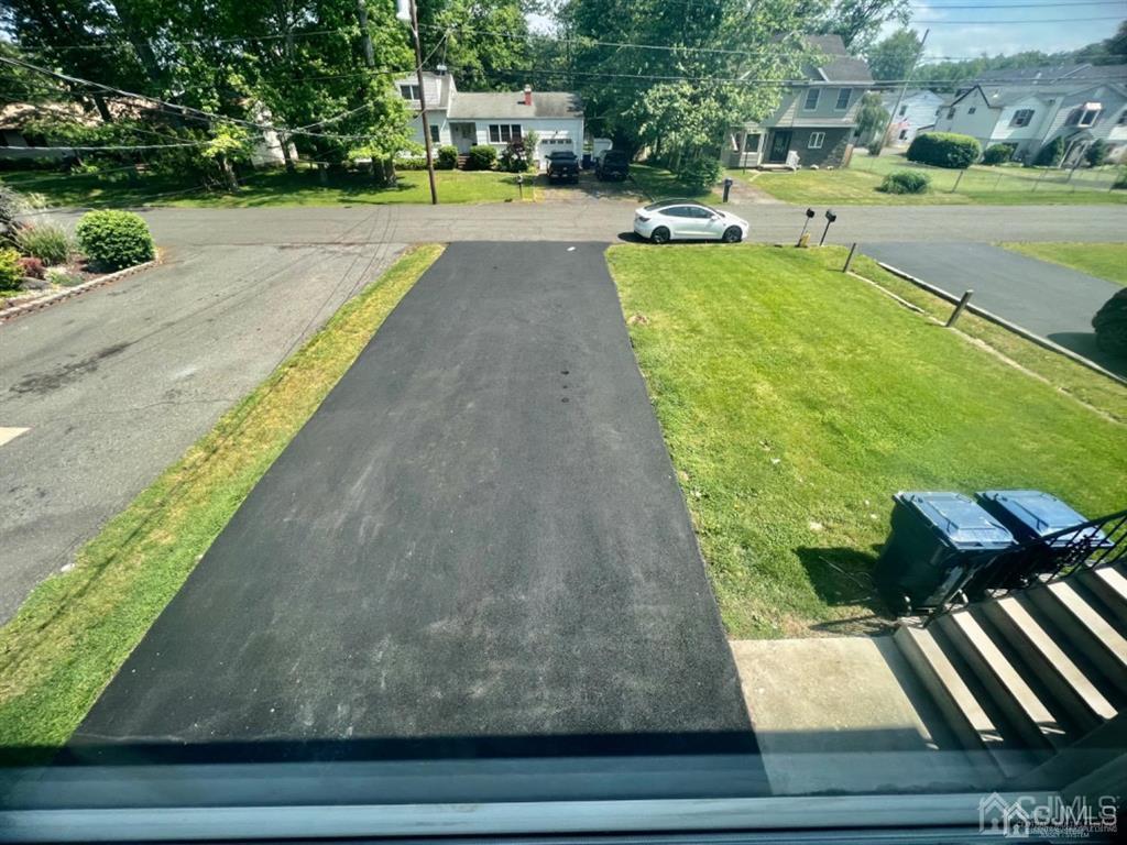 1577 Holly Road North Brunswick, NJ 08902 - Photo 5 of 15 a view of a swimming pool with lawn chairs and a yard