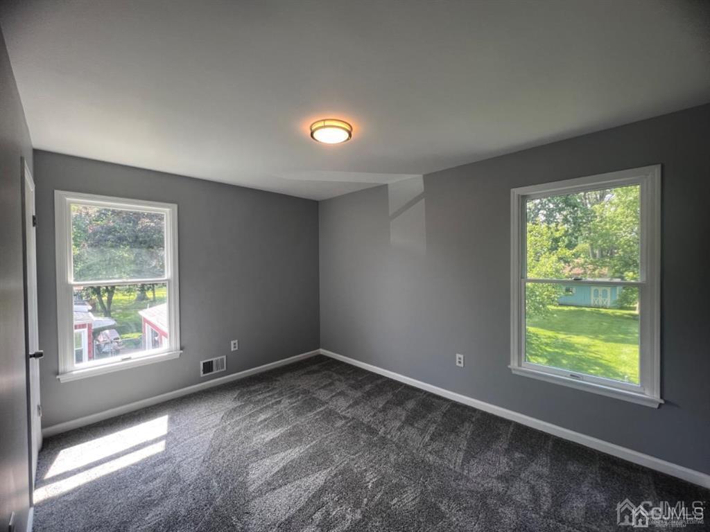 1577 Holly Road North Brunswick, NJ 08902 - Photo 6 of 15 a view of an empty room with a window