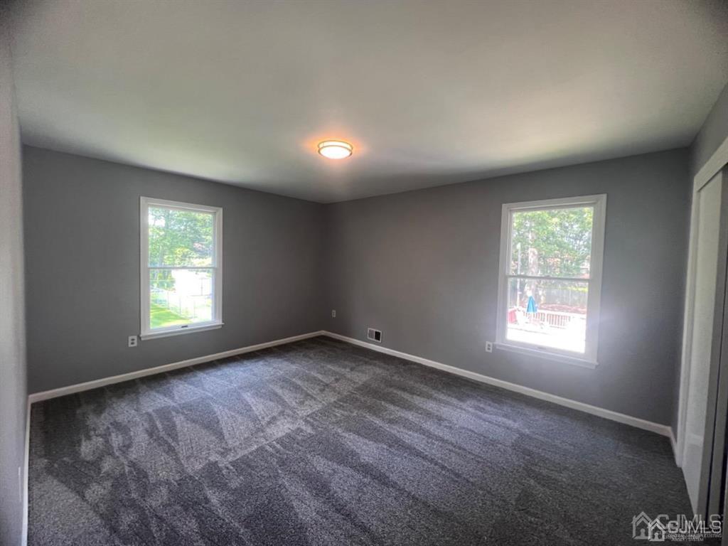 1577 Holly Road North Brunswick, NJ 08902 - Photo 7 of 15 a view of an empty room and window
