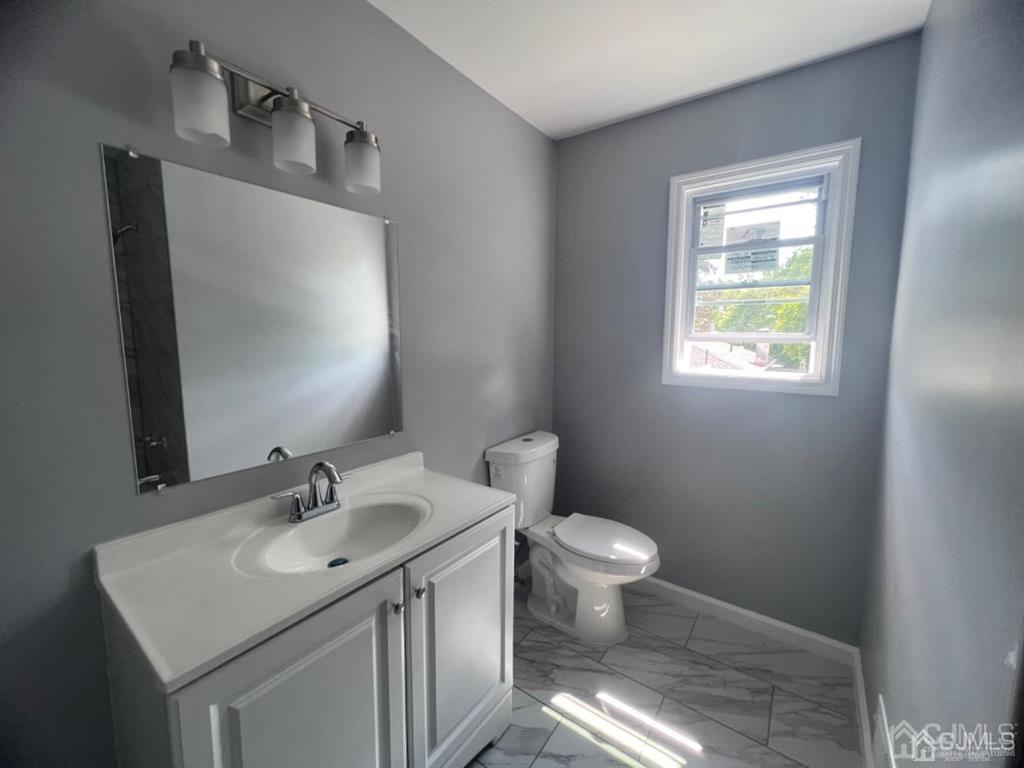 1577 Holly Road North Brunswick, NJ 08902 - Photo 8 of 15 a bathroom with a sink toilet and a window