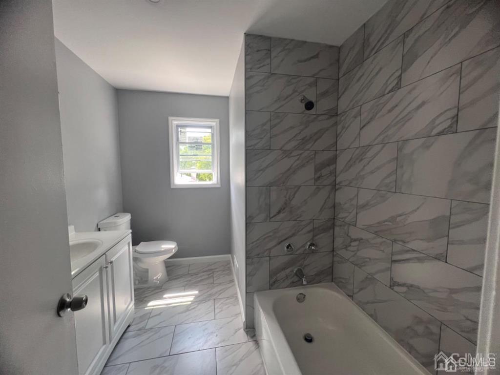 1577 Holly Road North Brunswick, NJ 08902 - Photo 9 of 15 a bathroom with a toilet sink and shower