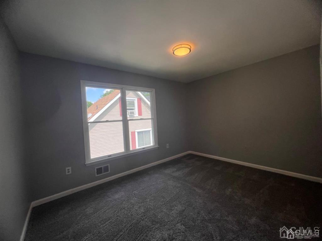 1577 Holly Road North Brunswick, NJ 08902 - Photo 10 of 15 an empty room with a empty space and a window