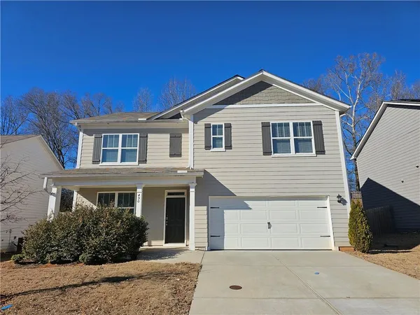 a front view of a house with yard