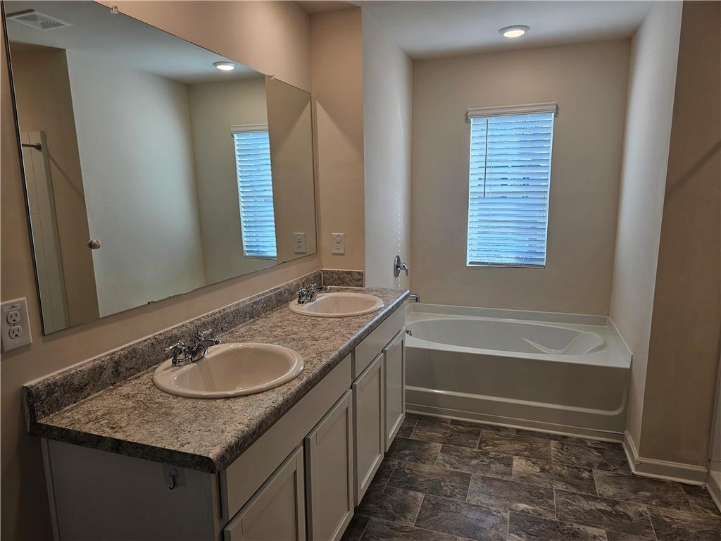 490 Walnut Grv Way Pendergrass, GA 30567 - Photo 20 of 23 a bathroom with a granite countertop sink and a mirror