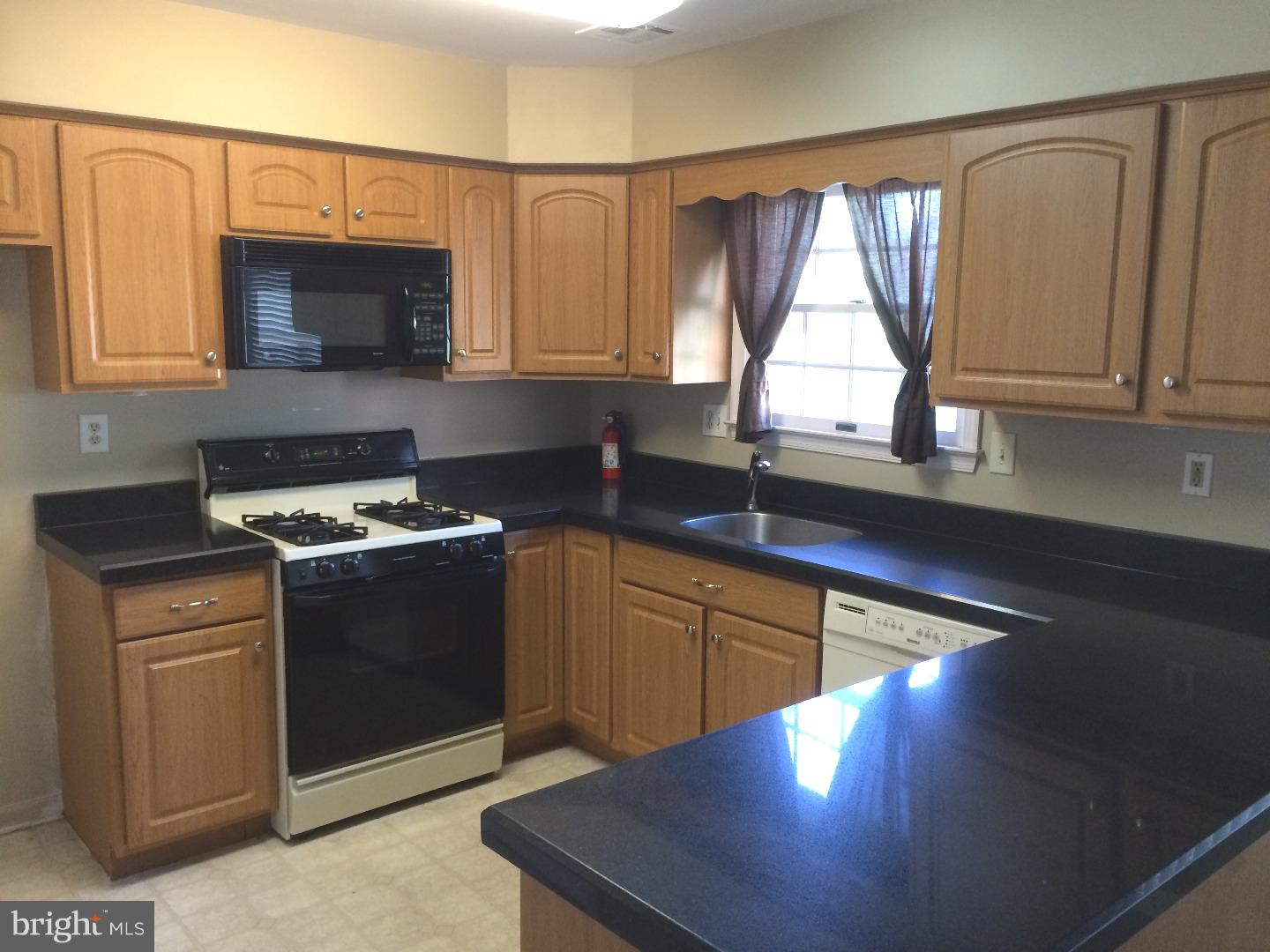 56 Manchester Road Eastampton, NJ 08060 - Photo 4 of 17 a kitchen with stainless steel appliances granite countertop a stove a sink and a microwave