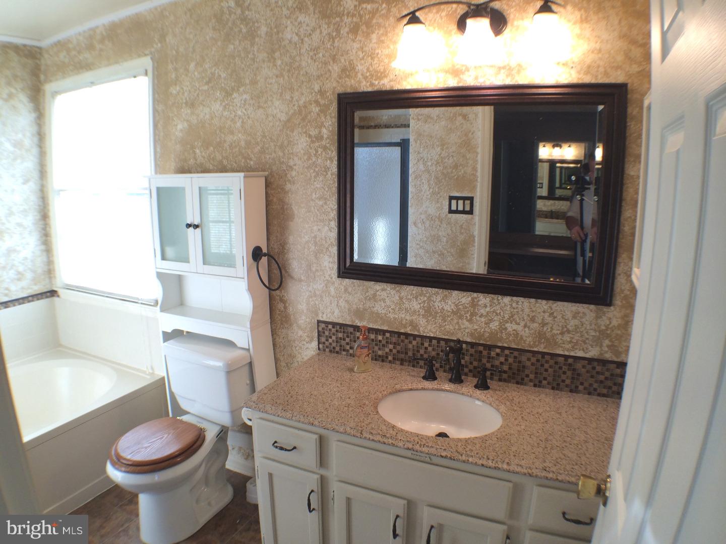 56 Manchester Road Eastampton, NJ 08060 - Photo 8 of 17 a bathroom with a toilet sink and mirror