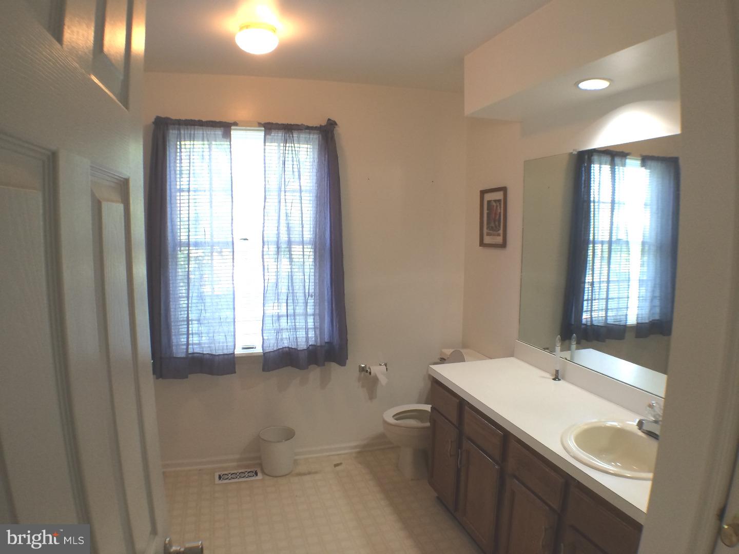 56 Manchester Road Eastampton, NJ 08060 - Photo 9 of 17 a bathroom with a granite countertop sink a toilet and mirror