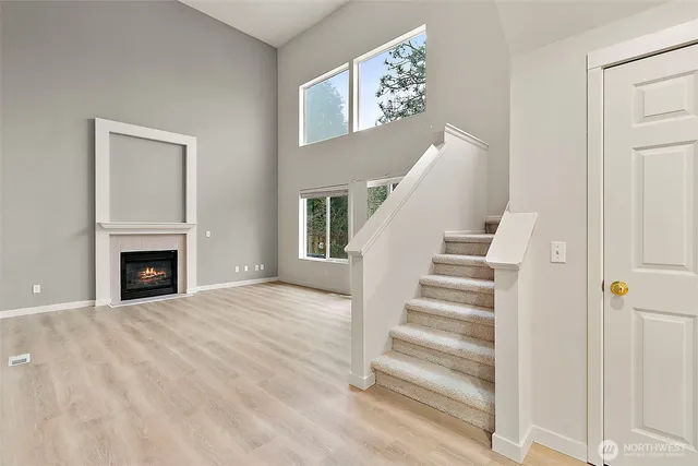 a view of a livingroom with wooden floor and fireplace
