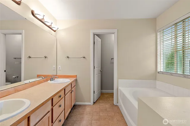 a spacious bathroom with sink shower and bathtub