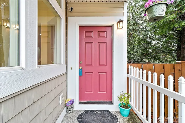 a view of a porch with a potted plant and floor to ceiling window