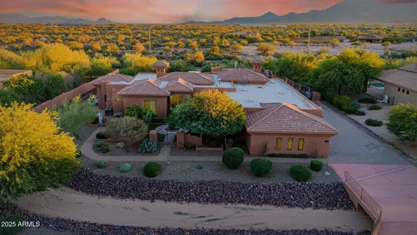 a view of a house with a garden and lake view