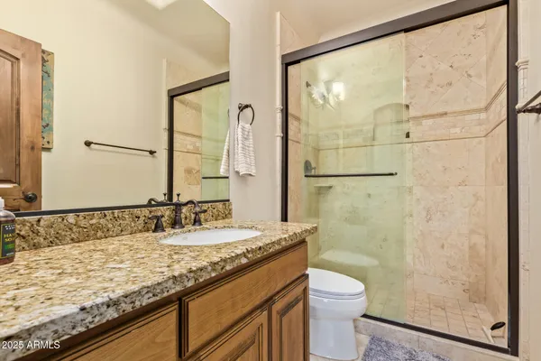 an aerial view of a house with swimming pool and ocean view