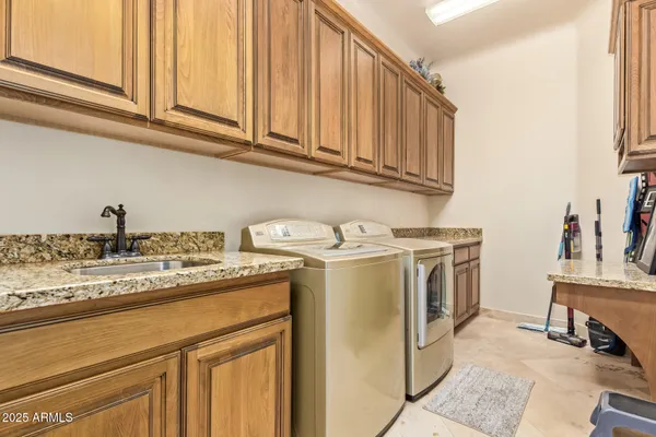 an aerial view of a house with swimming pool garden and patio